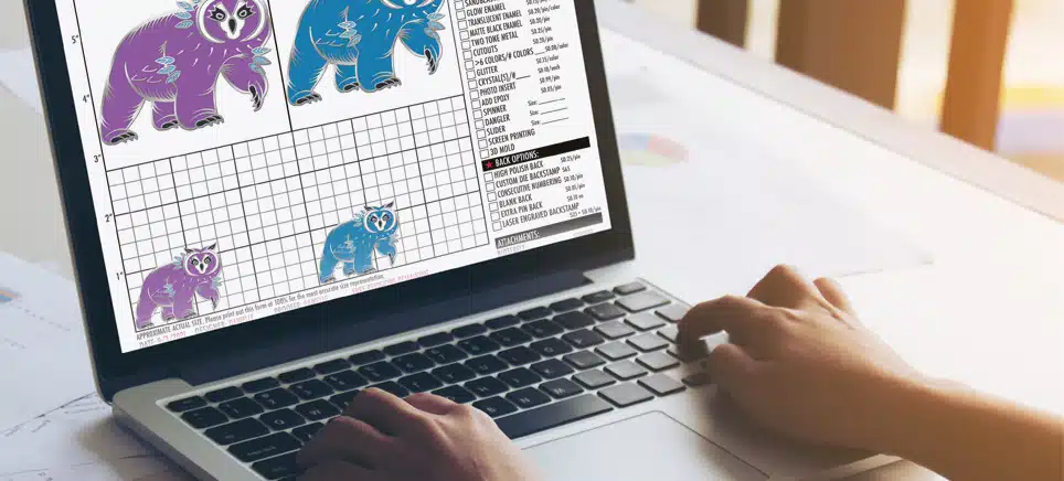 Designer preparing coin artwork on a laptop